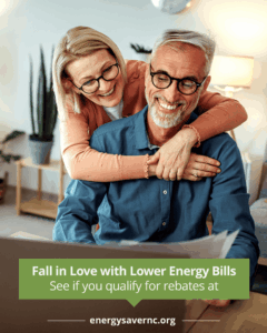 A smiling older couple looks at paperwork together. Text on image promotes lower energy bills and rebates at energysavernc.org.